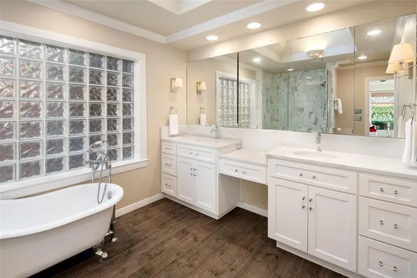 a bathroom with a granite countertop sink mirror bathtub and shower