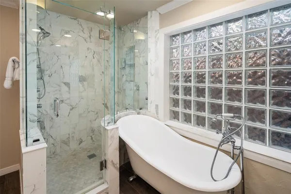 a bathroom with a granite countertop sink a toilet and shower