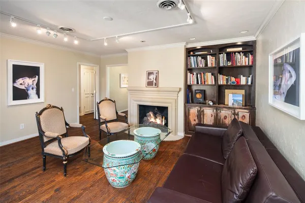 a living room with furniture and a bookshelf