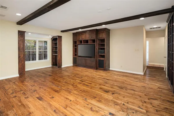 a view of an empty room with a kitchen