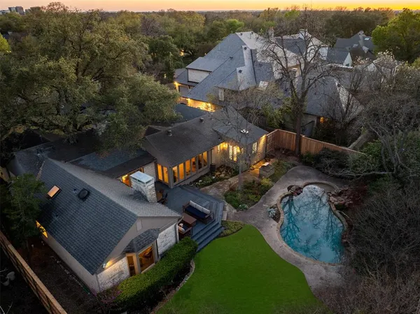 an aerial view of multiple houses with a yard