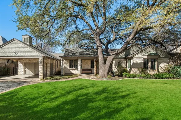 a front view of house with yard and green space