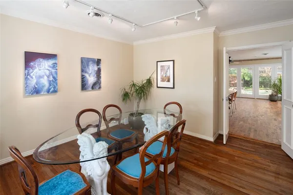 a dining room with furniture and wooden floor