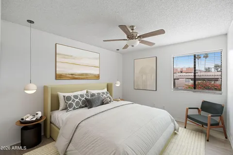 a bedroom with a large bed and a window
