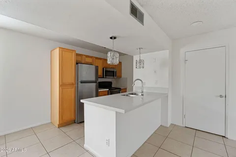 a utility room with cabinets washer and dryer