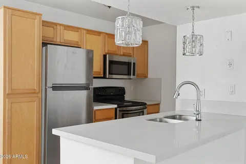 a kitchen with a refrigerator a stove a sink and a microwave