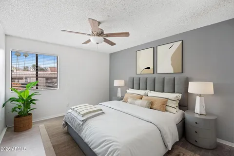 a bedroom with bed and a potted plant