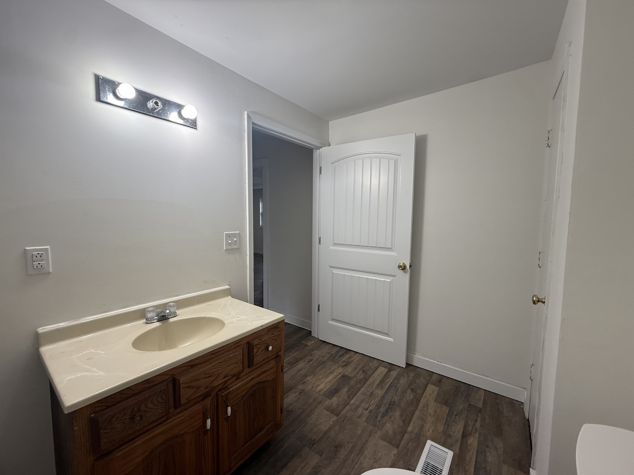 209 West 3rd Avenue Hohenwald, TN 38462 - Photo 12 of 12 a bathroom with a sink a toilet and a mirror