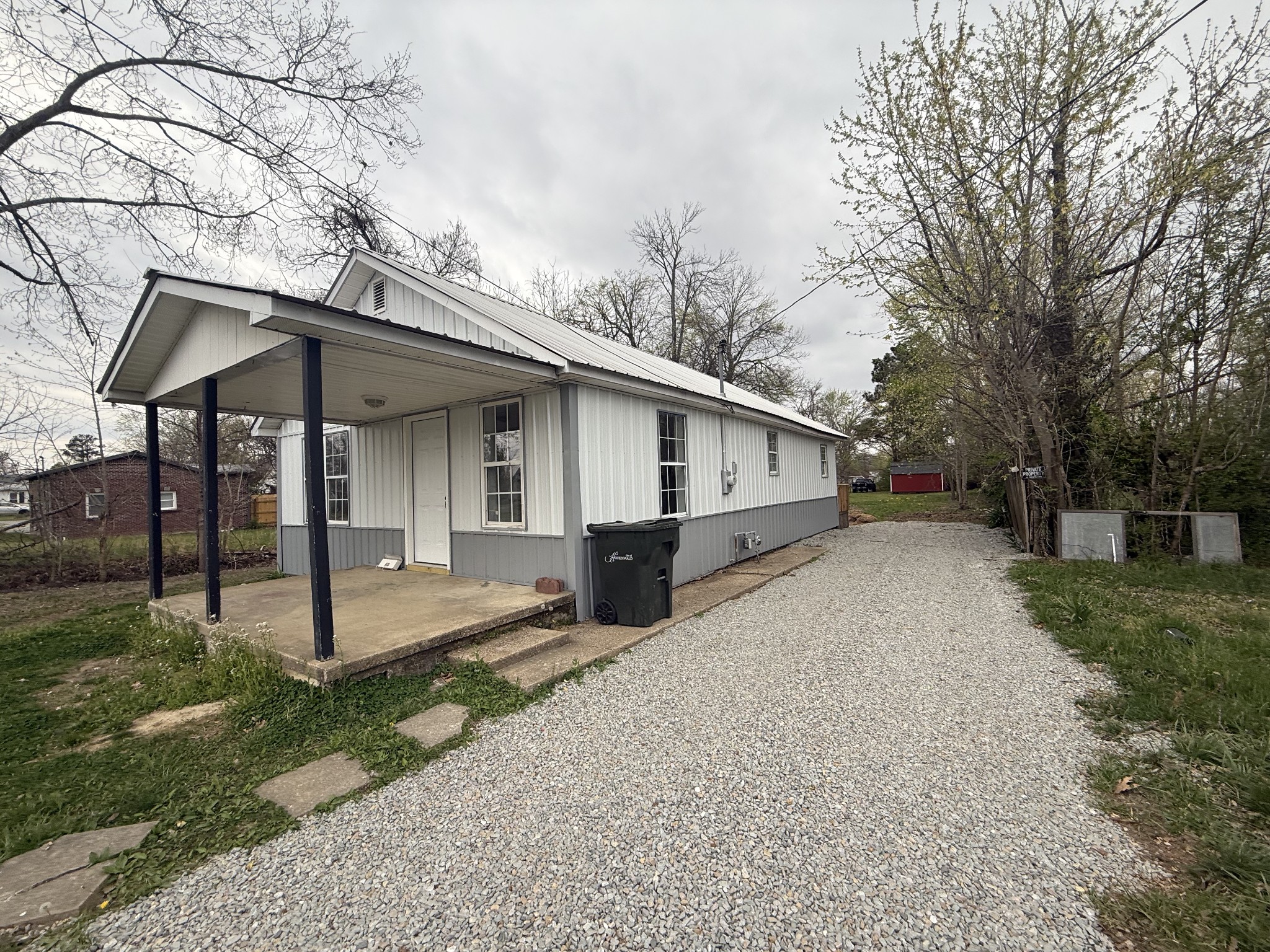 209 West 3rd Avenue Hohenwald, TN 38462 - Photo 2 of 12 a front view of house with yard and trees