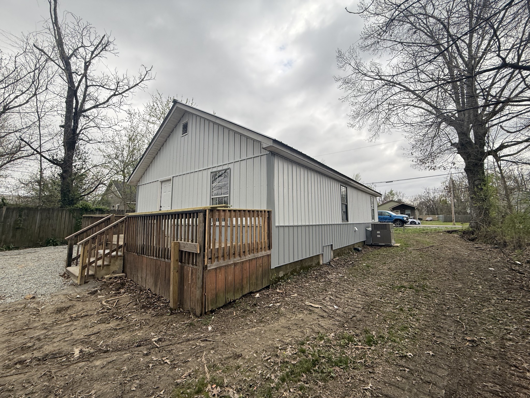 209 West 3rd Avenue Hohenwald, TN 38462 - Photo 4 of 12 a view of a house with a yard and wooden fence