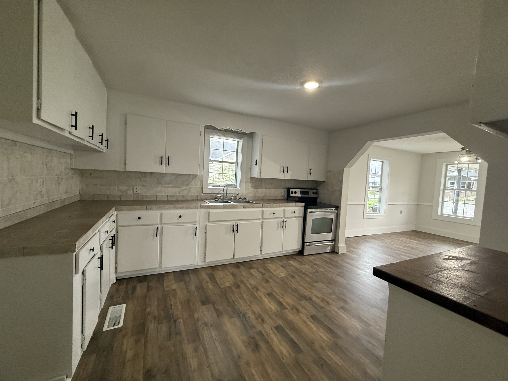 209 West 3rd Avenue Hohenwald, TN 38462 - Photo 6 of 12 a kitchen with granite countertop white cabinets and white appliances