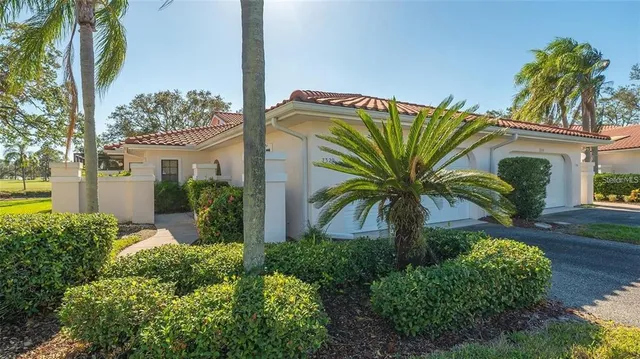 a view of a house with a potted plant and a palm tree