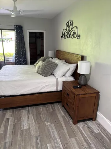 a bedroom with a bed and wooden floor