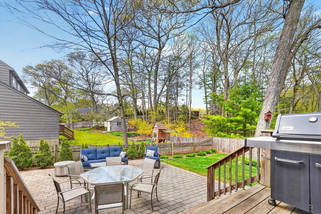 87 Payson Road Brookline, MA 02467 - Photo 36 of 41 a view of a swimming pool with a patio and wooden furniture