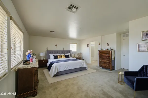 a bedroom with bed and a couch