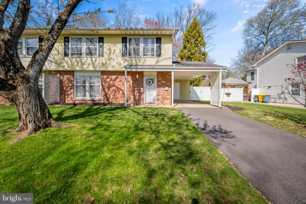 a front view of house with a garden