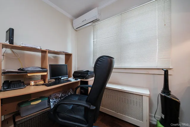 a view of a workspace with furniture and a window