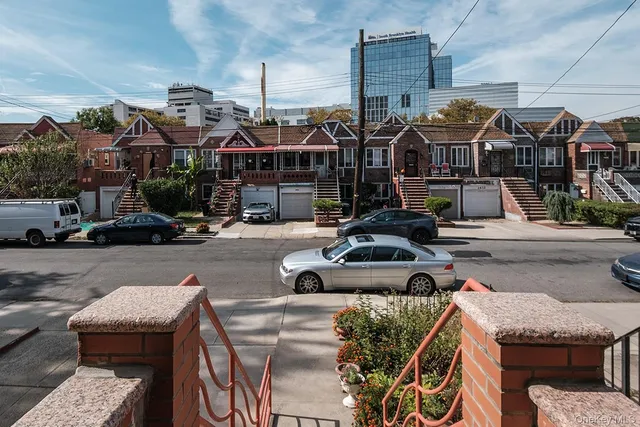 a street view with couple of cars parked