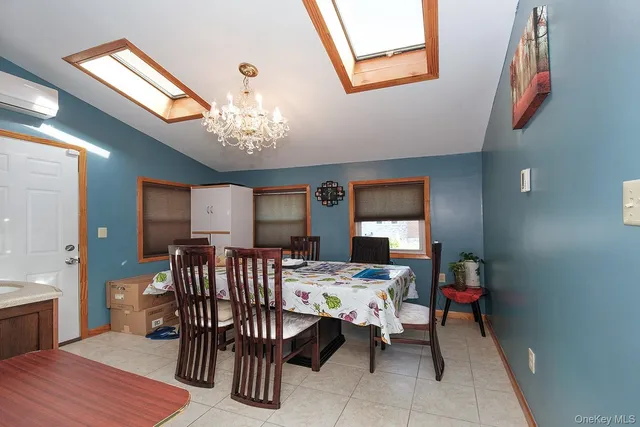 a view of a dining room with furniture and chandelier