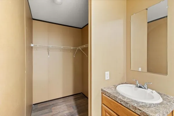a bathroom with a granite countertop sink and a mirror