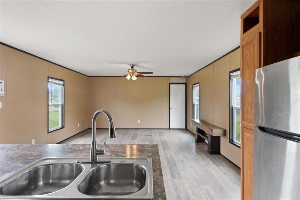 30 Galley Drive Denison, TX 75021 - Photo 8 of 18 a kitchen with a refrigerator sink and cabinets