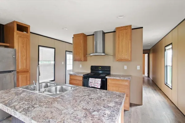a kitchen with granite countertop a sink and a stove top oven