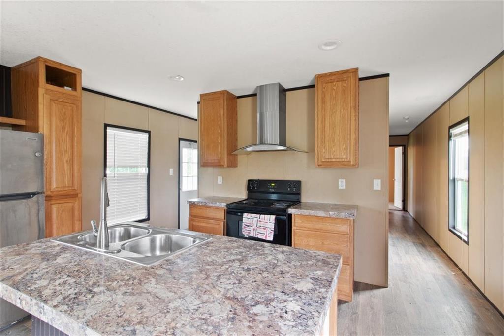 30 Galley Drive Denison, TX 75021 - Photo 9 of 18 a kitchen with granite countertop a sink and a stove top oven