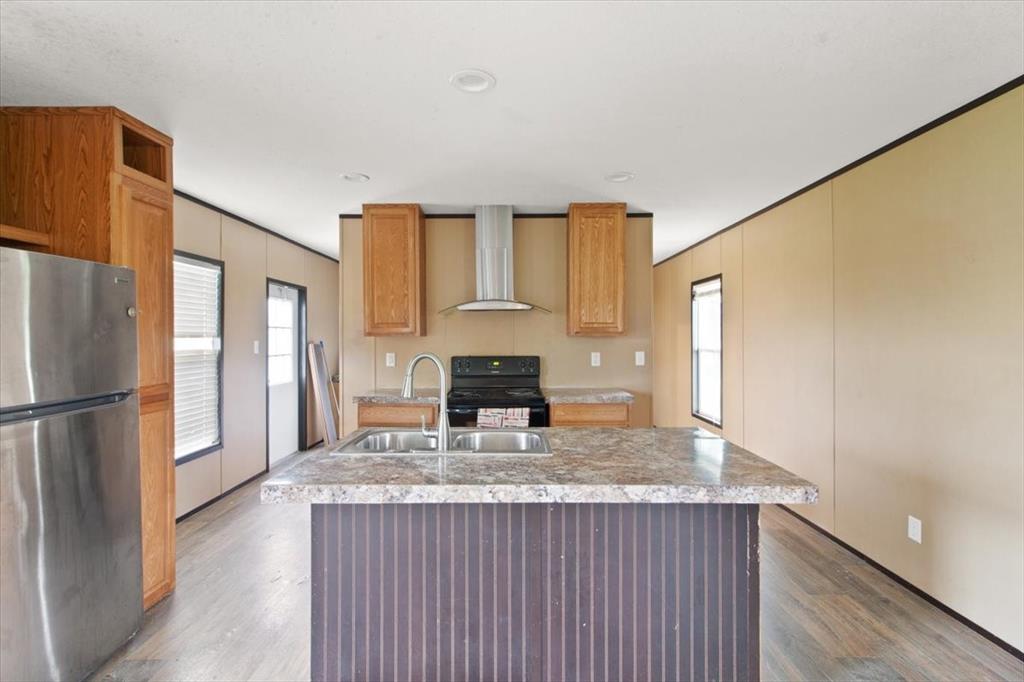 30 Galley Drive Denison, TX 75021 - Photo 10 of 18 a kitchen with granite countertop a refrigerator and a stove top oven