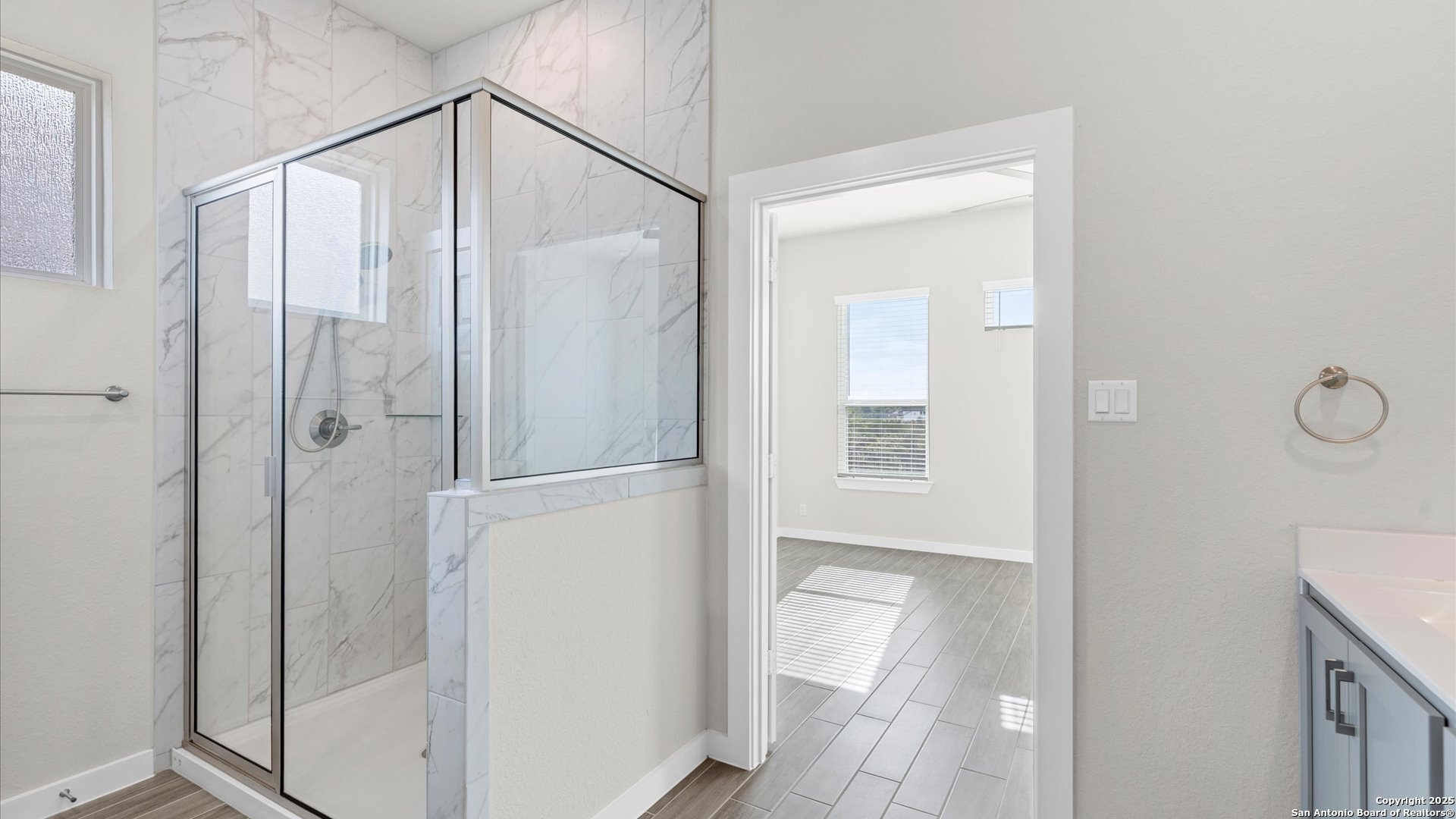 1551 Terrys Gate Road New Braunfels, TX 78132 - Photo 13 of 32 a bathroom with a glass shower door and mirror