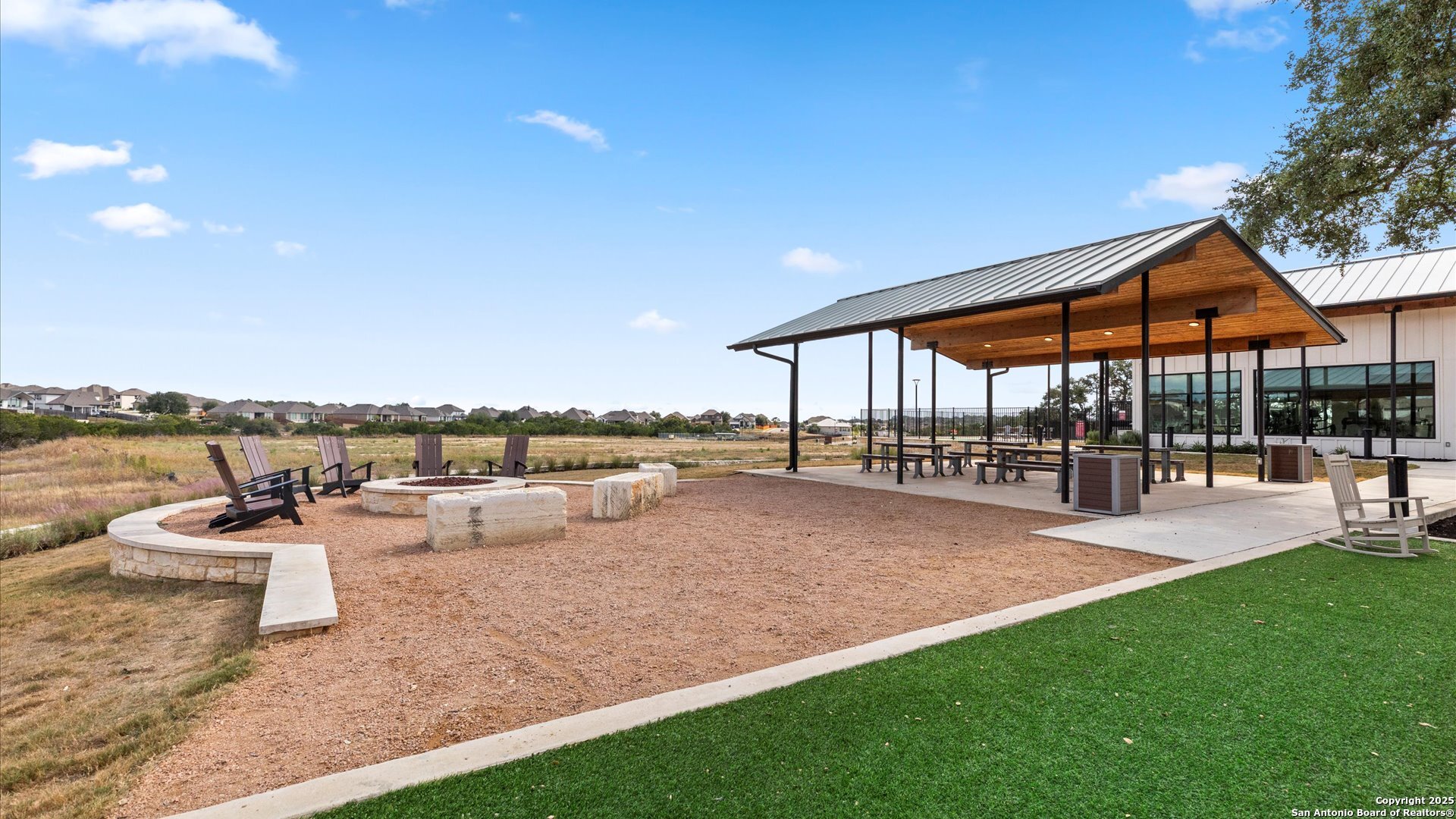 1551 Terrys Gate Road New Braunfels, TX 78132 - Photo 30 of 32 a view of a patio with couches and chairs under an umbrella