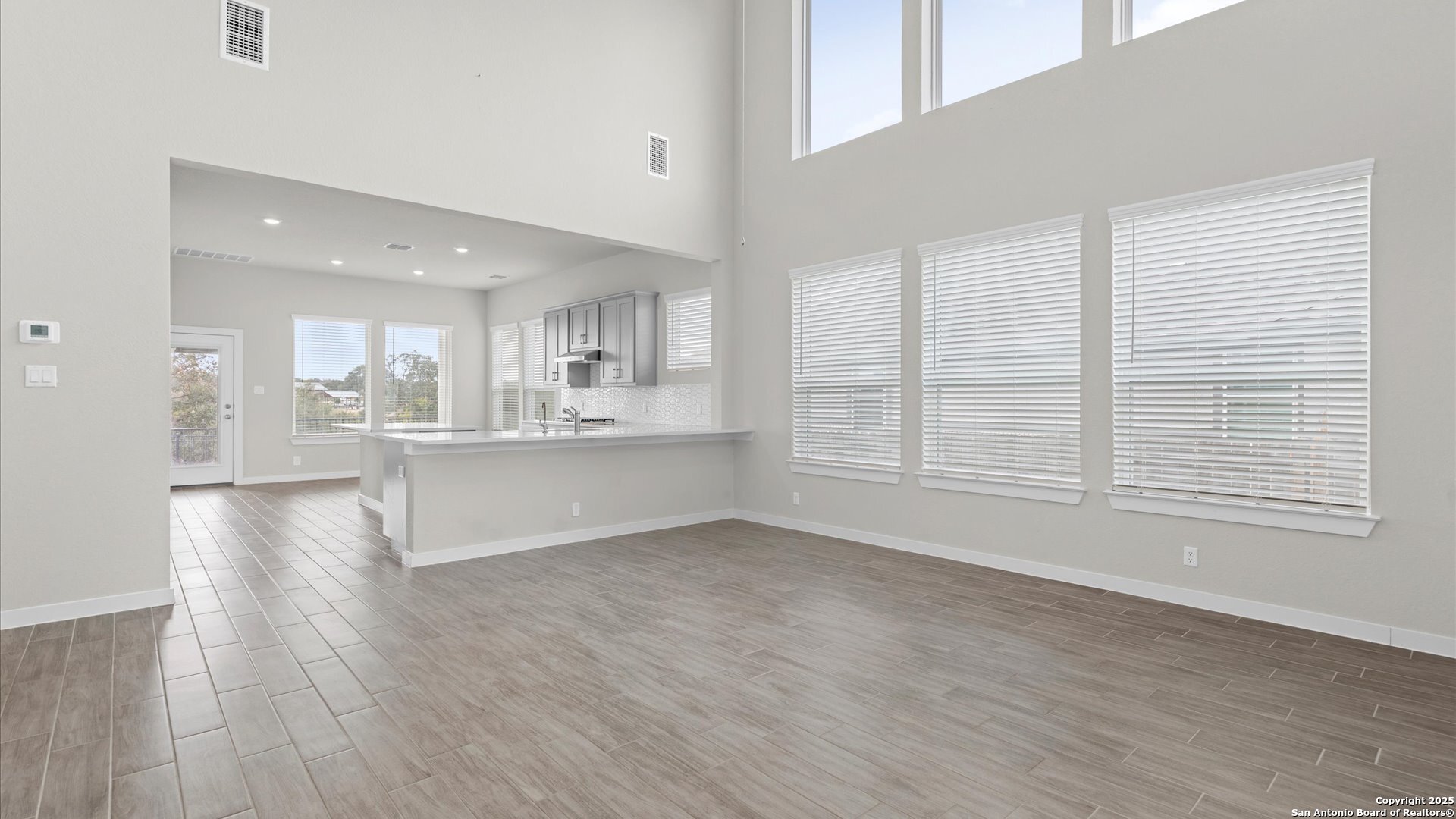 1551 Terrys Gate Road New Braunfels, TX 78132 - Photo 5 of 32 a view of kitchen with wooden floor and windows