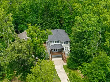 an aerial view of a house with a big yard