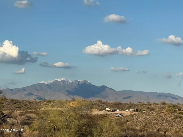 a view of mountain with sunset in background