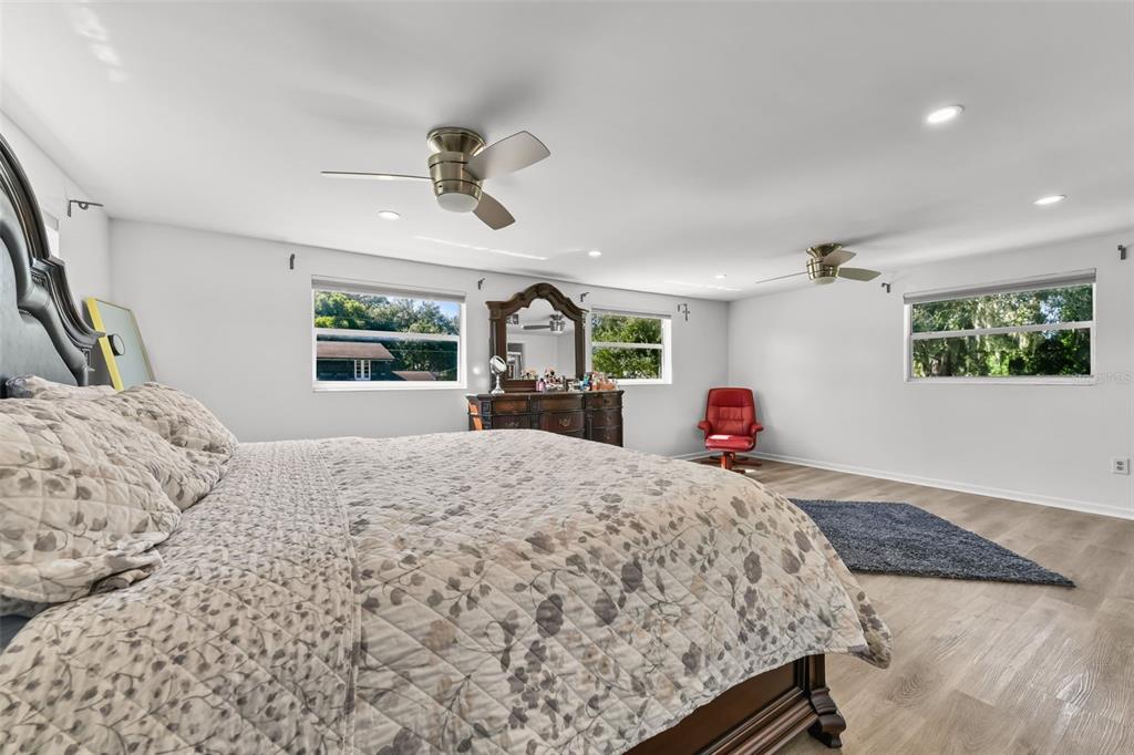 457 East Highland Street Altamonte Springs, FL 32701 - Photo 26 of 55 a bedroom with a large bed and a dresser