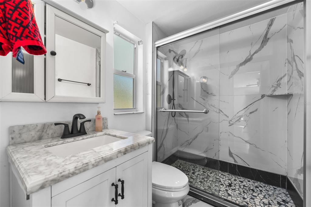 457 East Highland Street Altamonte Springs, FL 32701 - Photo 27 of 55 a bathroom with a granite countertop sink toilet and shower