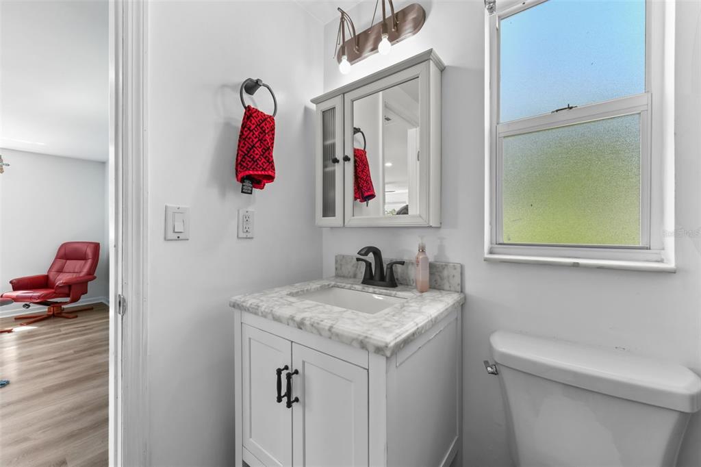 457 East Highland Street Altamonte Springs, FL 32701 - Photo 28 of 55 a bathroom with a granite countertop sink and a mirror
