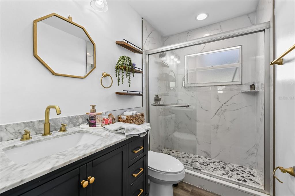 457 East Highland Street Altamonte Springs, FL 32701 - Photo 31 of 55 a bathroom with a granite countertop sink toilet and shower