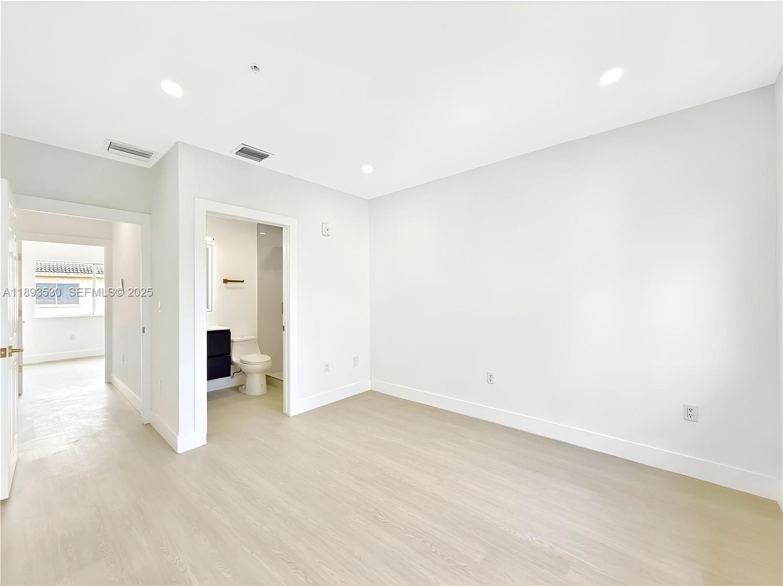 7985 Northwest 8th Street, Unit 109A Miami, FL 33126 - Photo 11 of 14 wooden floor in an empty room