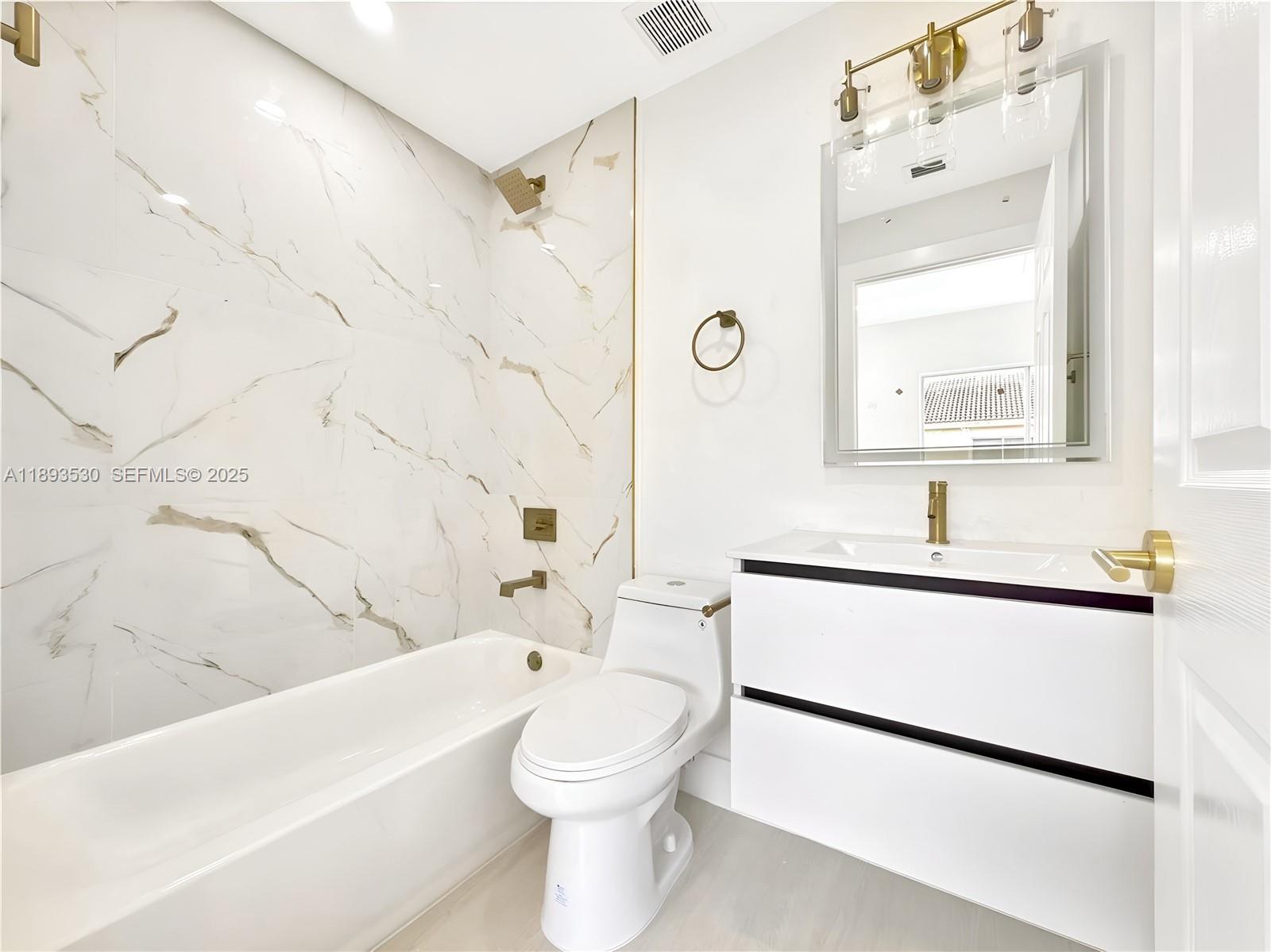 7985 Northwest 8th Street, Unit 109A Miami, FL 33126 - Photo 12 of 14 a bathroom with a sink a toilet and shower