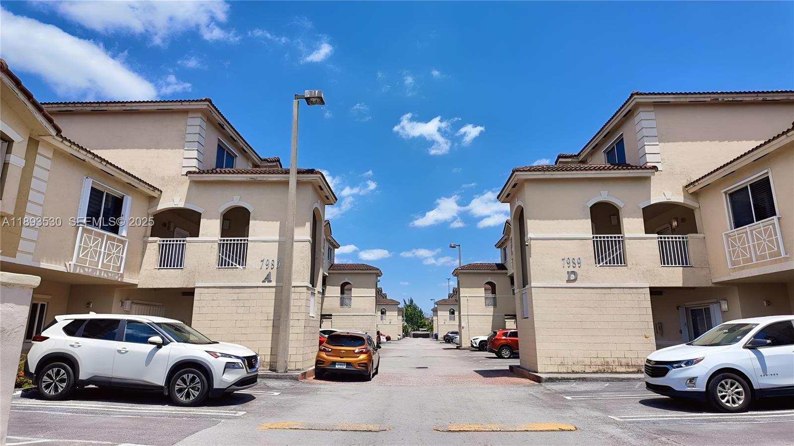 7985 Northwest 8th Street, Unit 109A Miami, FL 33126 - Photo 13 of 14 a view of a street that has couple of cars parked on the road