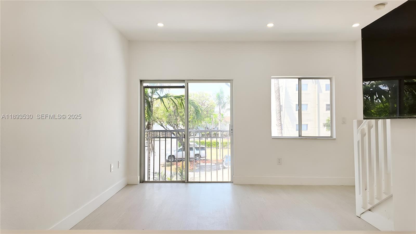 7985 Northwest 8th Street, Unit 109A Miami, FL 33126 - Photo 2 of 14 a view of an empty room with a window