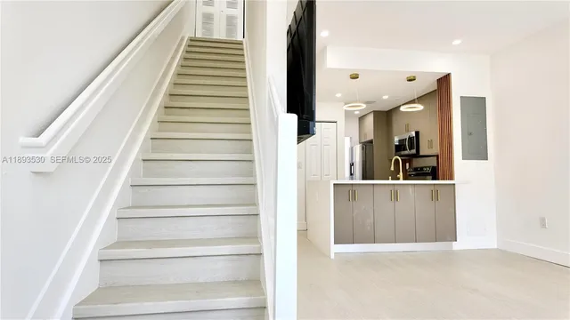 a view of entryway and hall with wooden floor