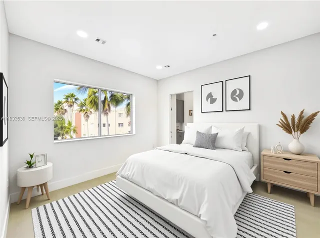 a bedroom with a bed and a painting on the wall