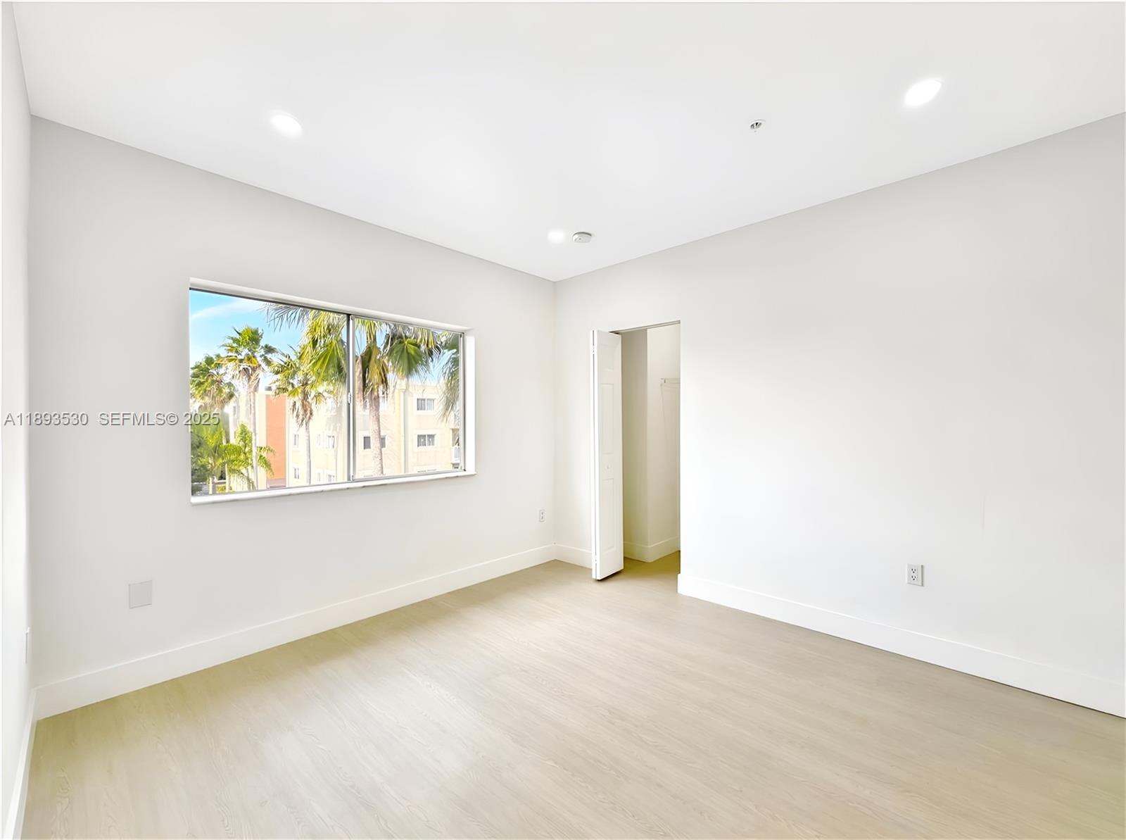 7985 Northwest 8th Street, Unit 109A Miami, FL 33126 - Photo 7 of 14 an empty room with windows