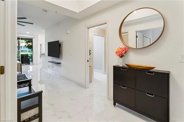 a view of a livingroom with furniture and mirror