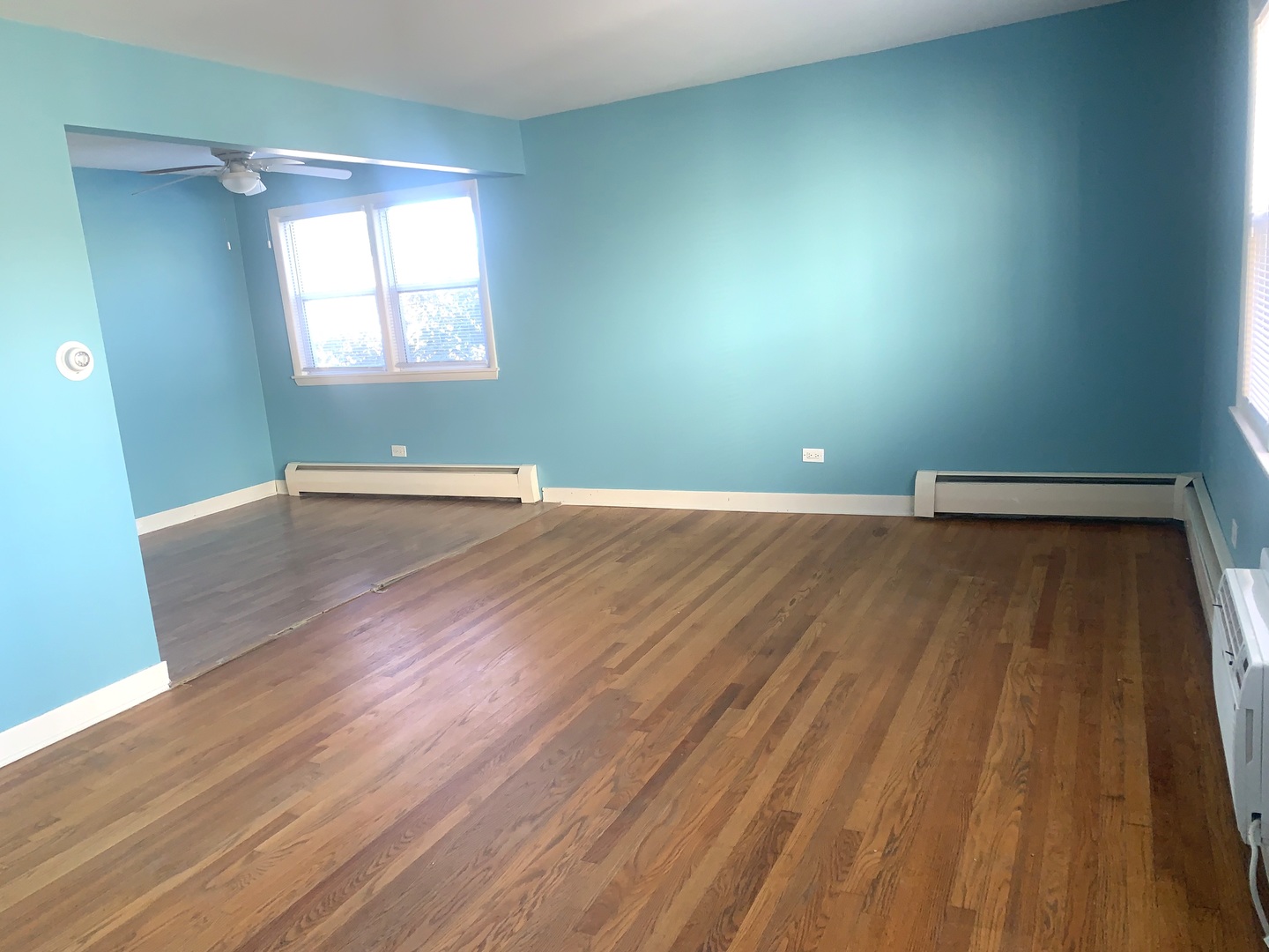 4347 West 63rd Street, Unit 2A Chicago, IL 60629 - Photo 2 of 15 an empty room with wooden floor and windows
