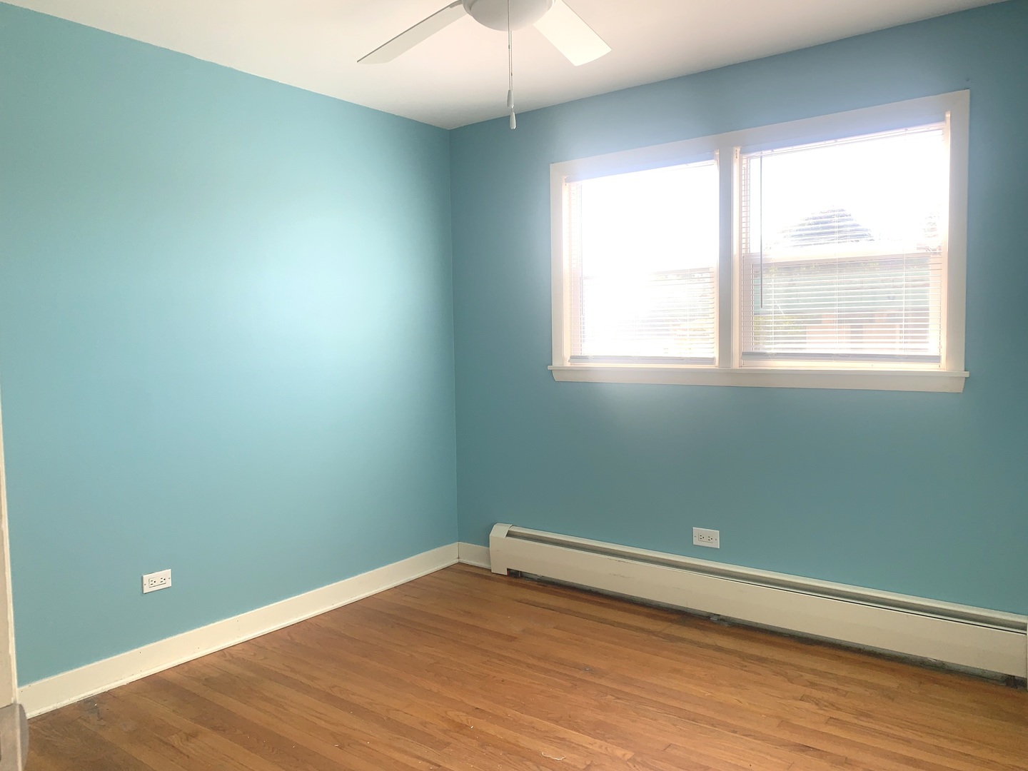 4347 West 63rd Street, Unit 2A Chicago, IL 60629 - Photo 6 of 15 an empty room with wooden floor and windows