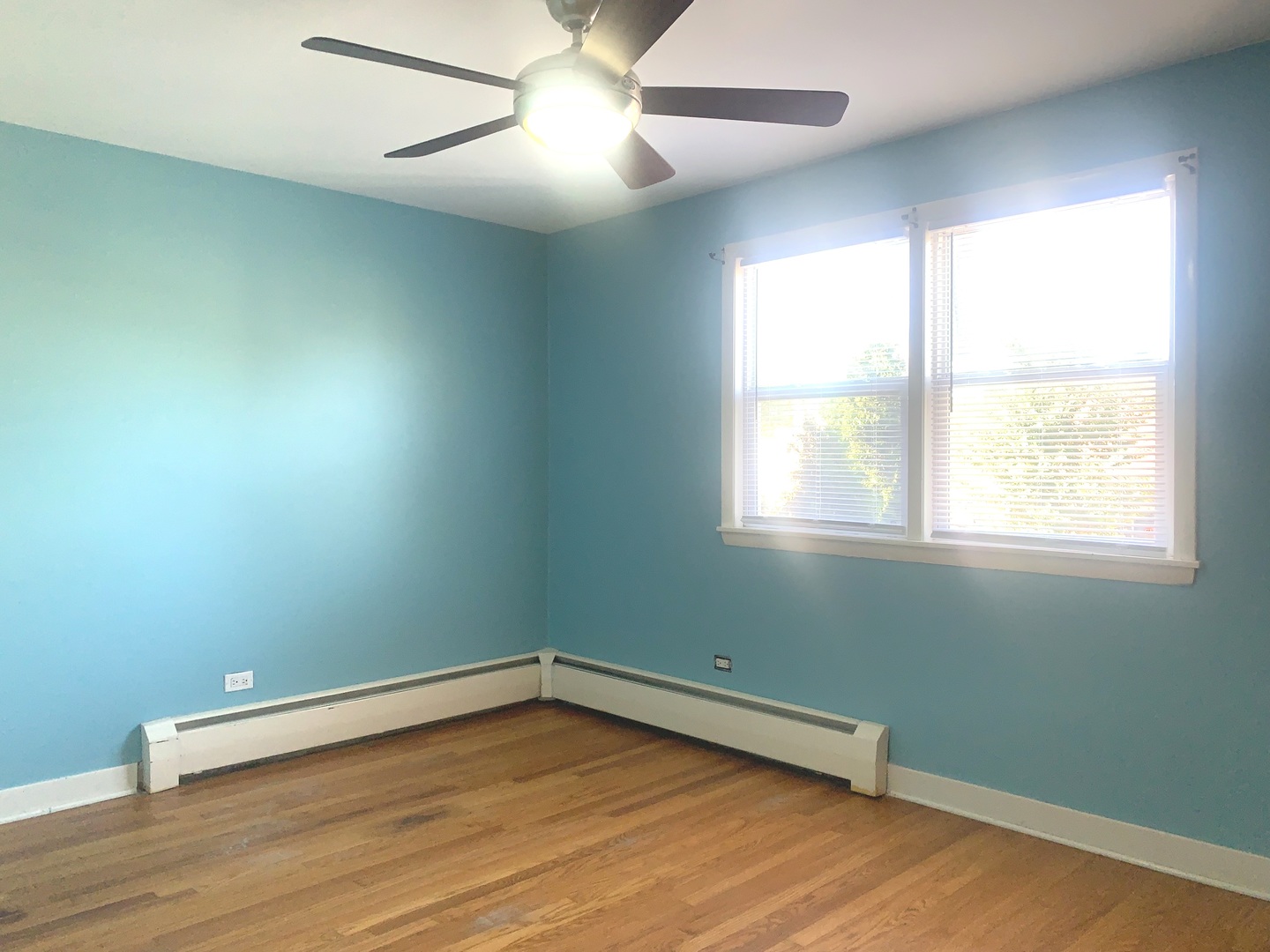 4347 West 63rd Street, Unit 2A Chicago, IL 60629 - Photo 7 of 15 an empty room with wooden floor and windows