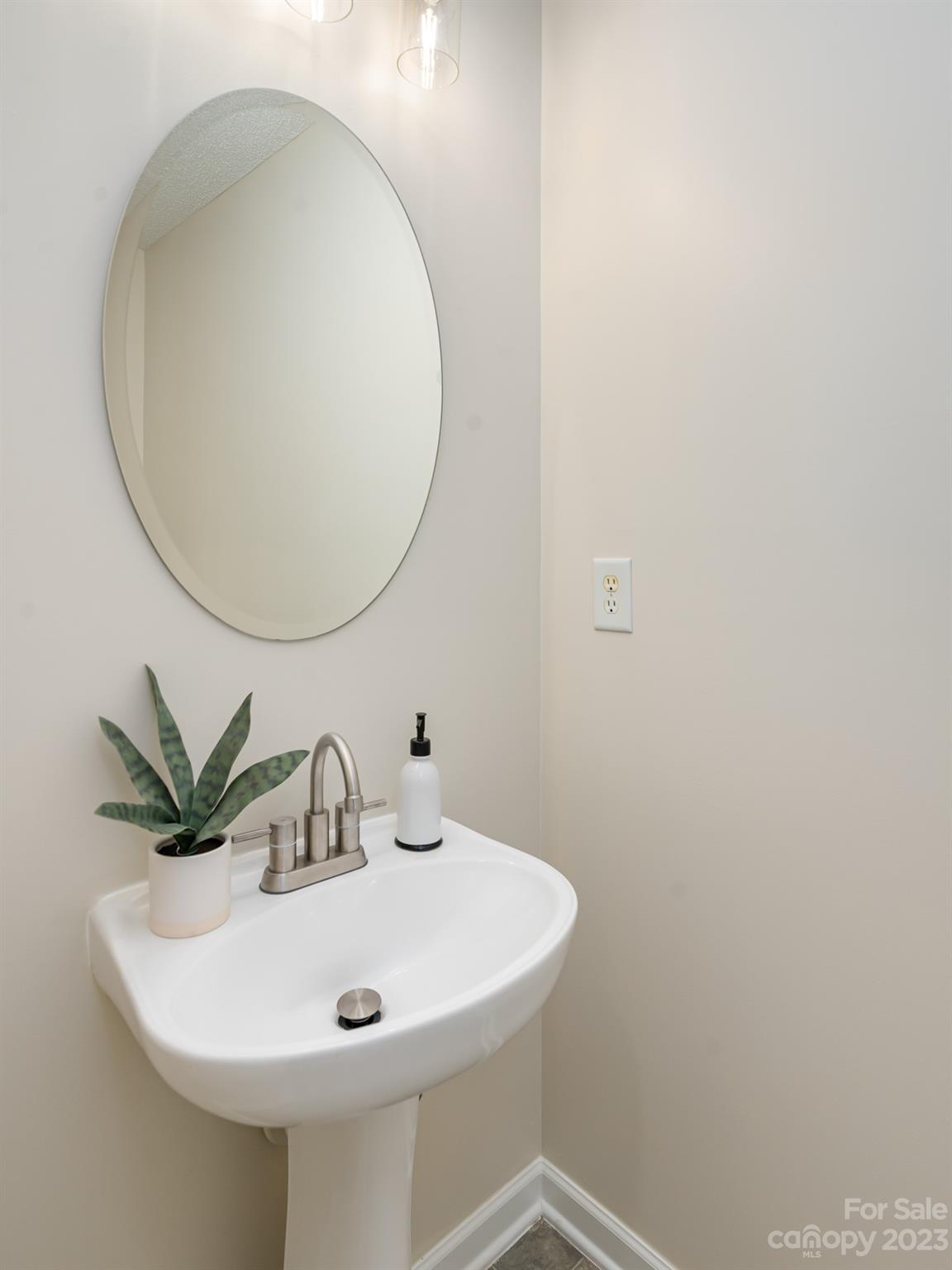 8158 Rudolph Road Charlotte, NC 28216 - Photo 11 of 23 a bathroom with a sink and a mirror