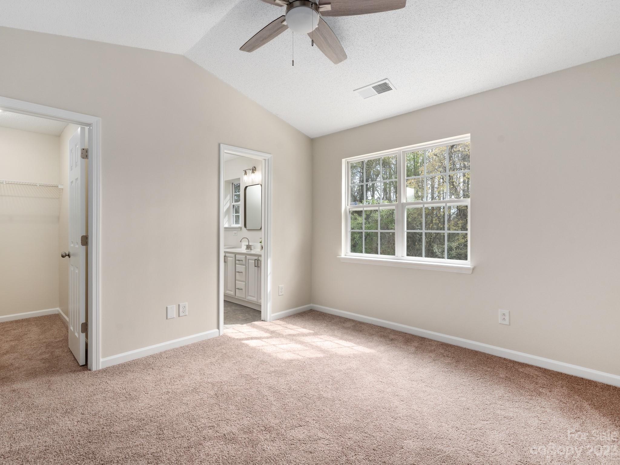 8158 Rudolph Road Charlotte, NC 28216 - Photo 14 of 23 an empty room with a window and a ceiling fan